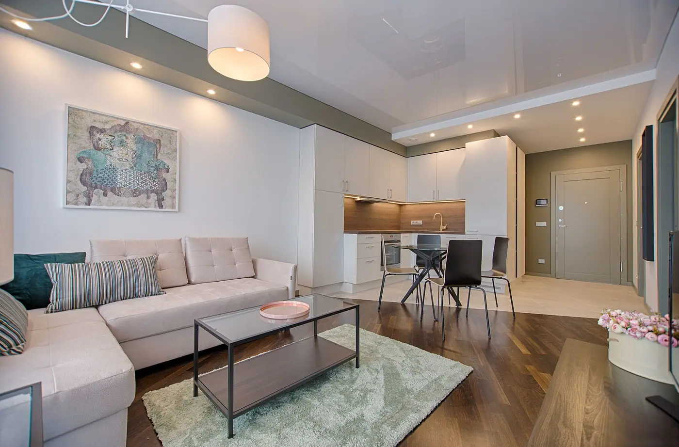 Small apartment with a sofa, a dining table, and a kitchen along one wall