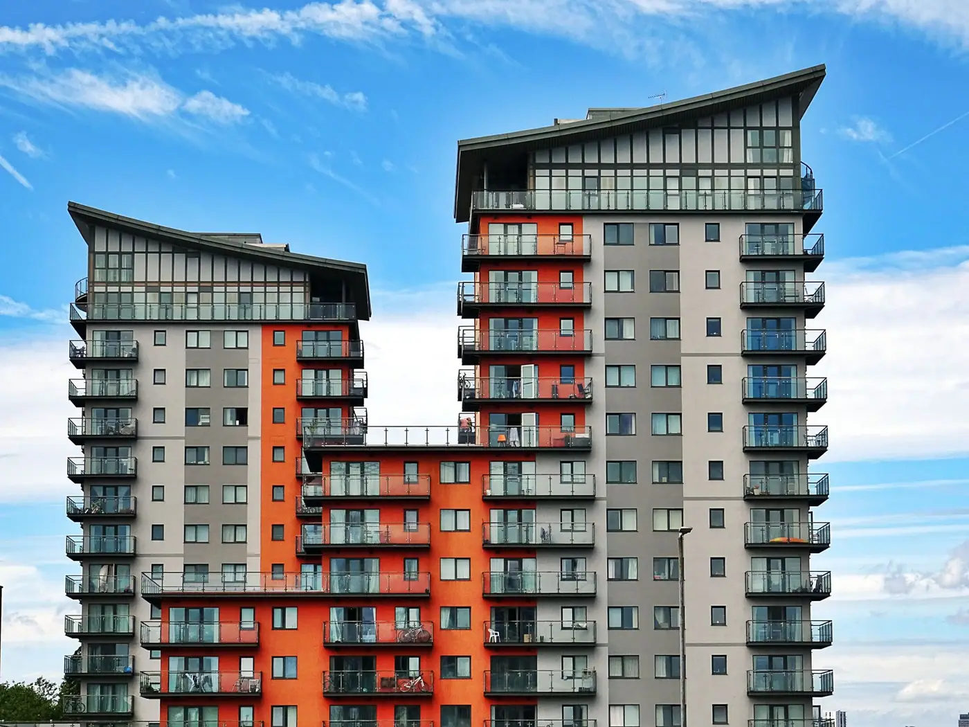 Orange and gray apartment towers with repeated balconies